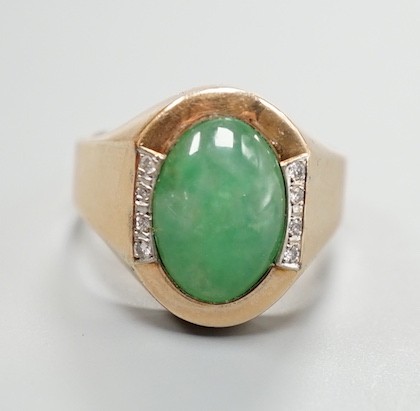 A 14k, cabochon jade and diamond chip set dress ring, size R/S, gross 7.6 grams.